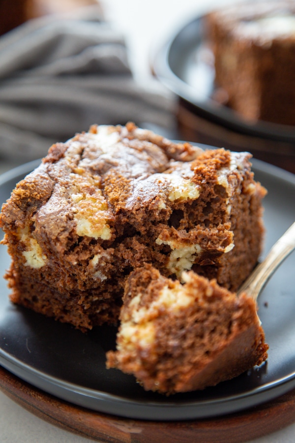 a slice of cake on a gray plate with a fork.