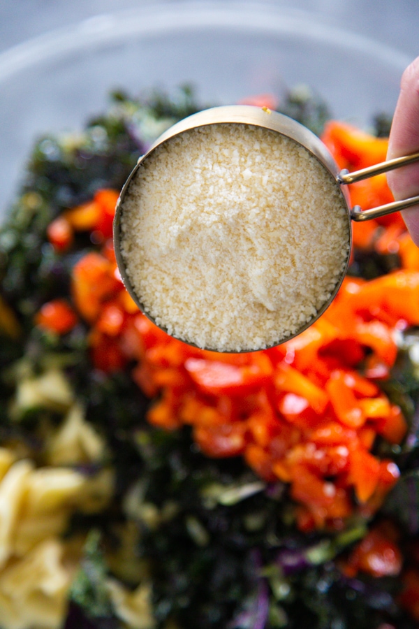 Parmesan cheese being added to the salad.