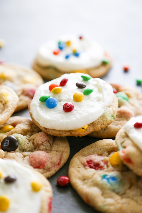a frosted cookie on top of unfrosted ones.