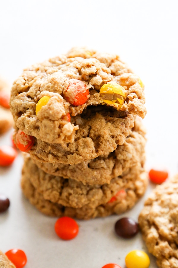 a stack of cookies with a bite taken out of the top one.