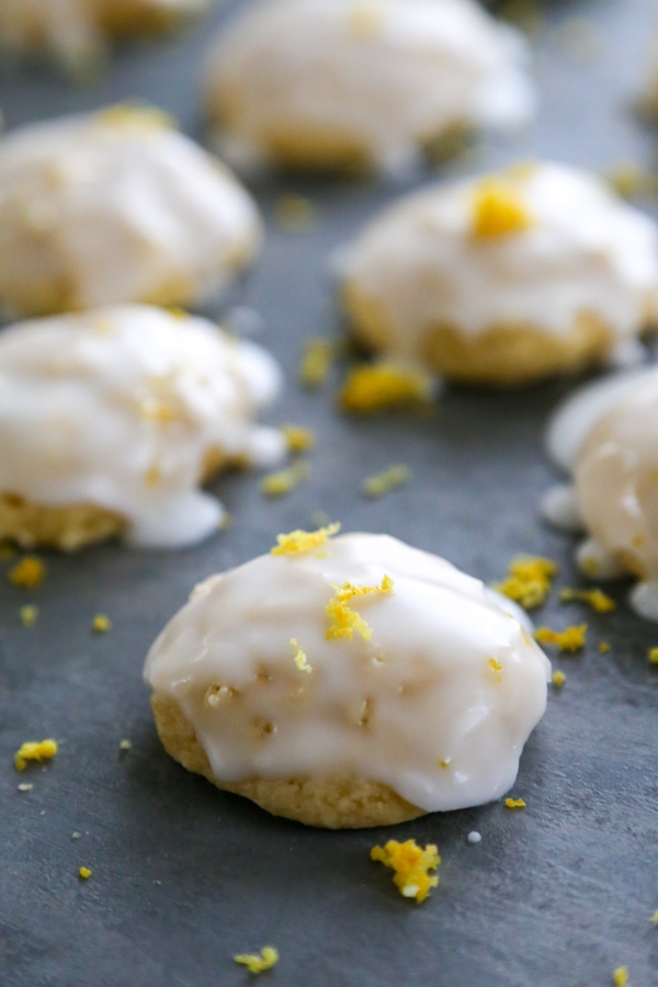 close-up of one anginetti cookie with others in the background.
