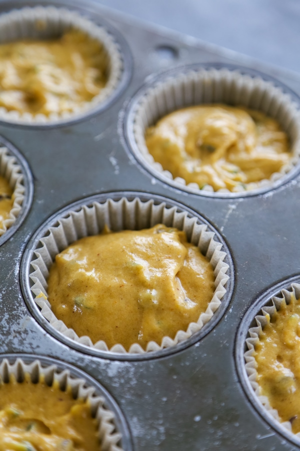close up shot of a muffin pan filled will batter.