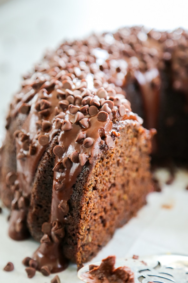 Triple Chocolate Zucchini Cake is just as delicious as it sounds. Chocolate, chocolate, chocolate, and zucchini. This is the best way to eat zucchini. Close-up pf a bundt cake.