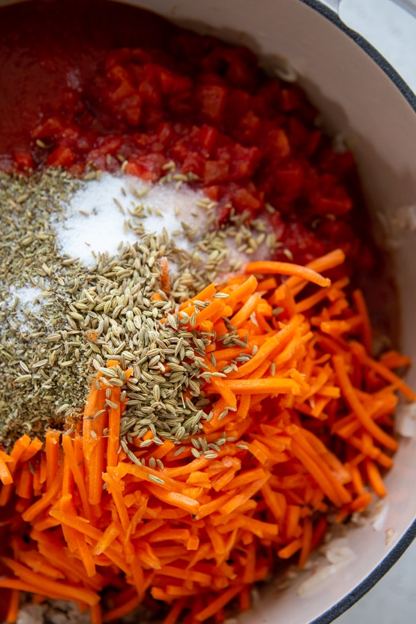 the tomatoes, carrots, and seasonings added to the pan.