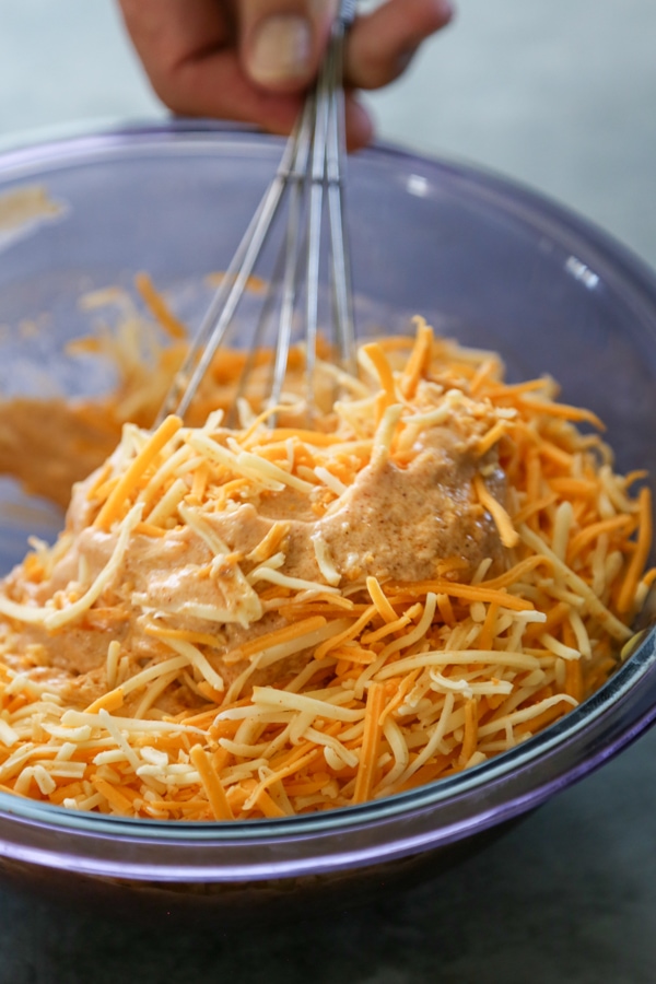 the chicken enchilada filling being mixed in a bowl.