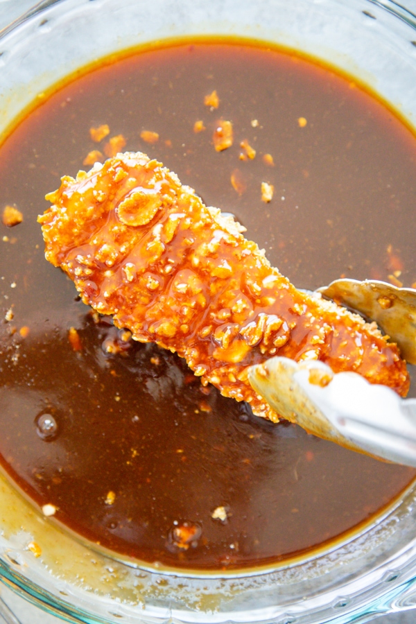 a piece of chicken coated in the sauce.