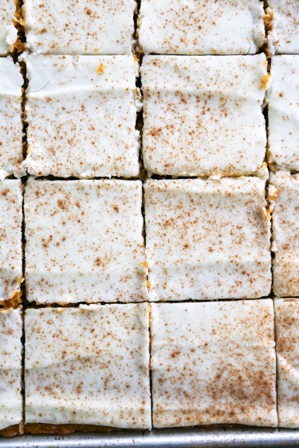overhead photo of frosted and sliced pumpkin bars.