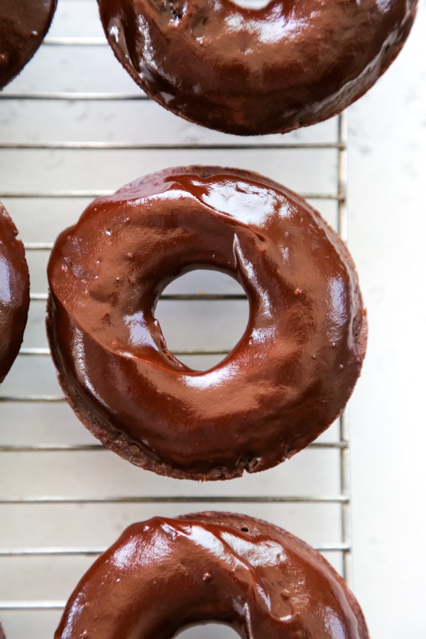 chocolate glazed donuts on a rack.