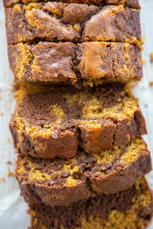 Pumpkin Nutella Swirl Bread takes pumpkin, chocolate, & hazelnut to a new level. Not only is it a beauty to look at, it's moist and full of fall flavors. Overhead photo of the sliced loaf.