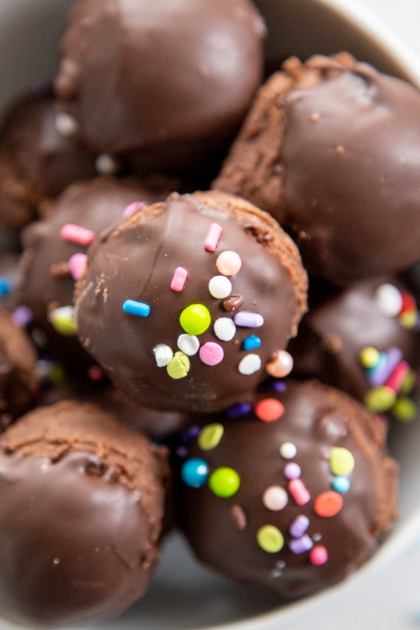 Overhead photo of brownie bites topped with chocolate and sprinkles.