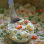 a ladle of chicken pot pie soup.