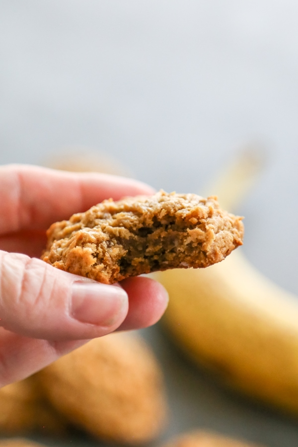 Chewy HEALTHY PEANUT BUTTER BANANA COOKIES are a twist on your peanut butter cookie recipe. Made with no butter and less sugar, they make a great snack! a cookies with a bite taken out of it.