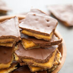 a stack of peanut butter toffee on a plate.