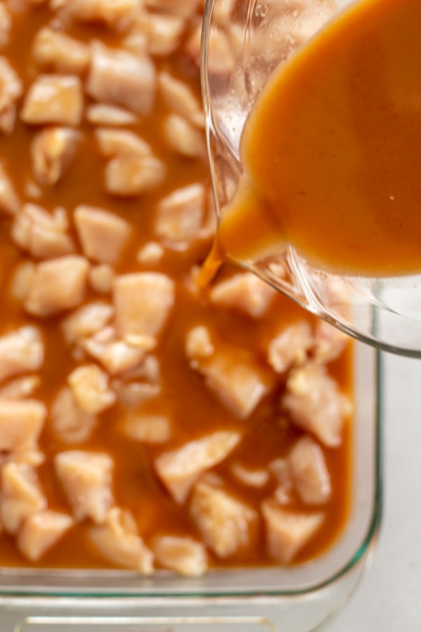 the sauce being added to the pan.