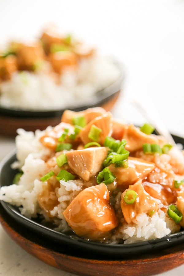 sweet and sour chicken with rice on a plate.