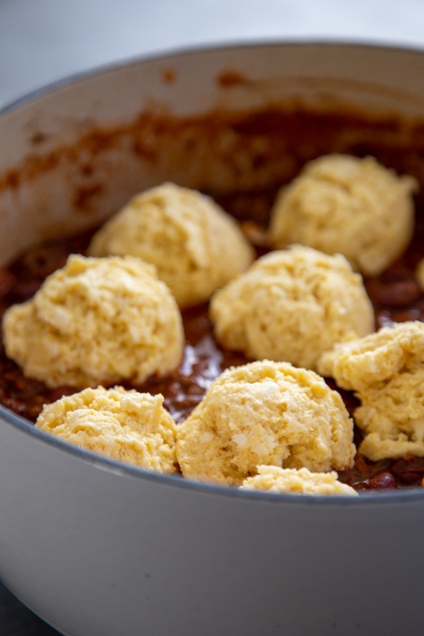 The biscuit dough dropped on top of the chili.