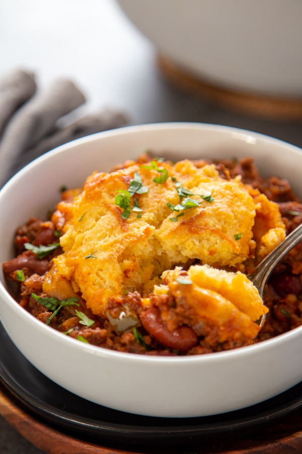 bowl of chili with cornmeal biscuit