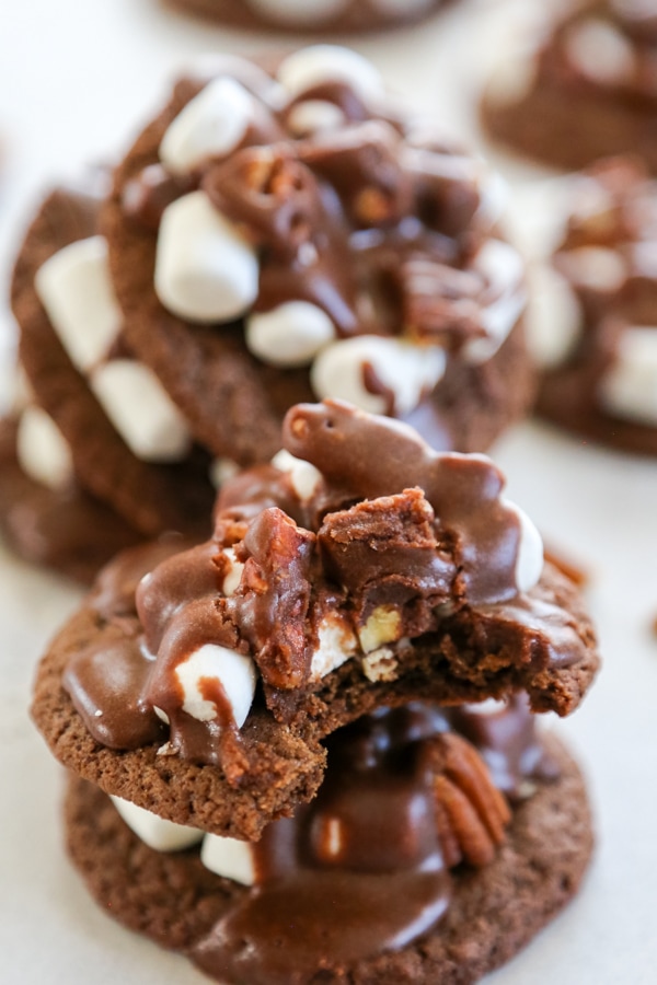 These Mississippi Mud Cookies are rich, gooey chocolate pecan cookies that are an insanely delicious twist of the classic pie. close-up shot of a stack of two cookies.