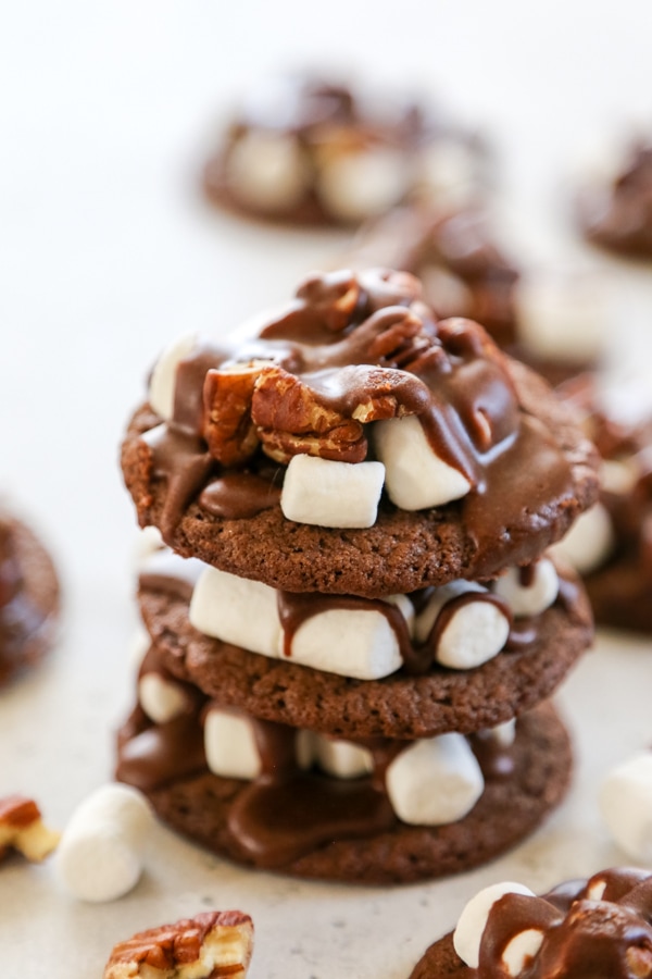These Mississippi Mud Cookies are rich, gooey chocolate pecan cookies that are an insanely delicious twist of the classic pie. a stack of three cookies.