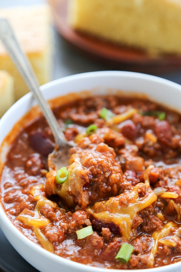a bowl of chili with a spoon.