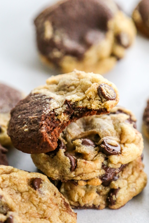 a stack of cookies with a bite taken out of the top one.