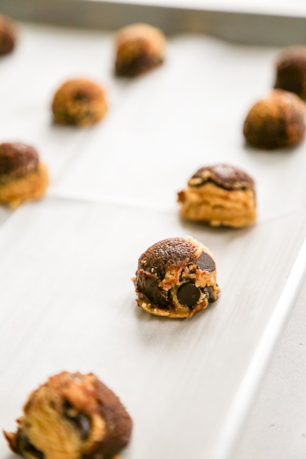 cookie dough balls on a baking sheet.