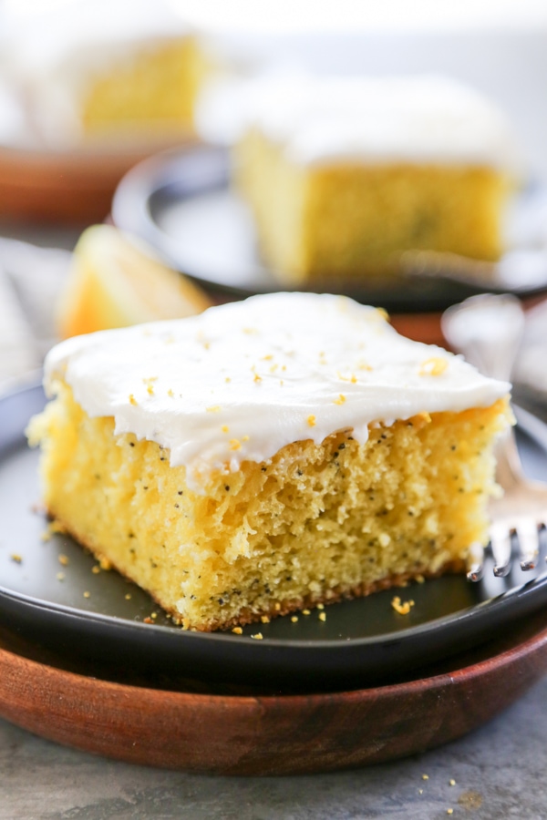 a slice of frosted cake on a plate.