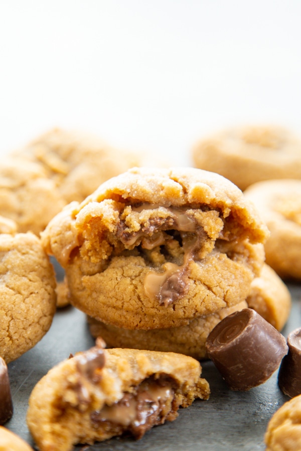 Rolo Stuffed Peanut Butter Cookies are soft and chewy peanut butter cookies with a delicious, melt in your mouth chocolate & caramel center. a stack of rolo cookies.