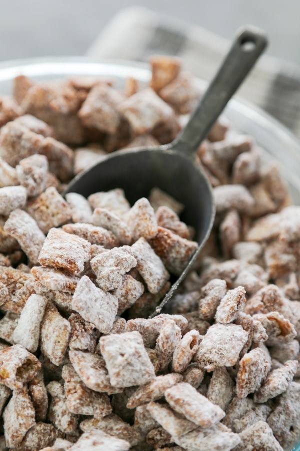 a bowl of muddy buddies with scopper