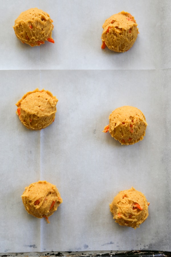 cookie dough balls on a baking sheet.