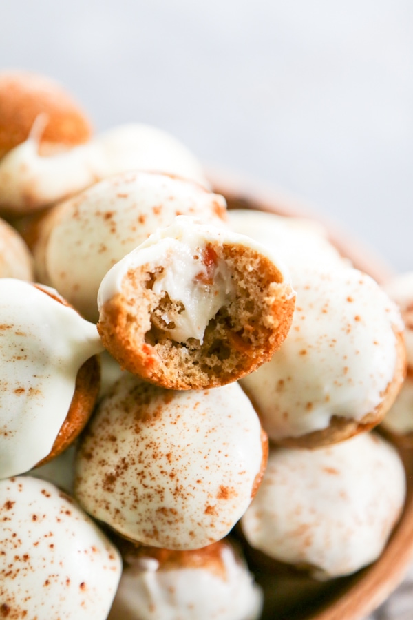 close-up shot of donut holes with a bite taken out of one.