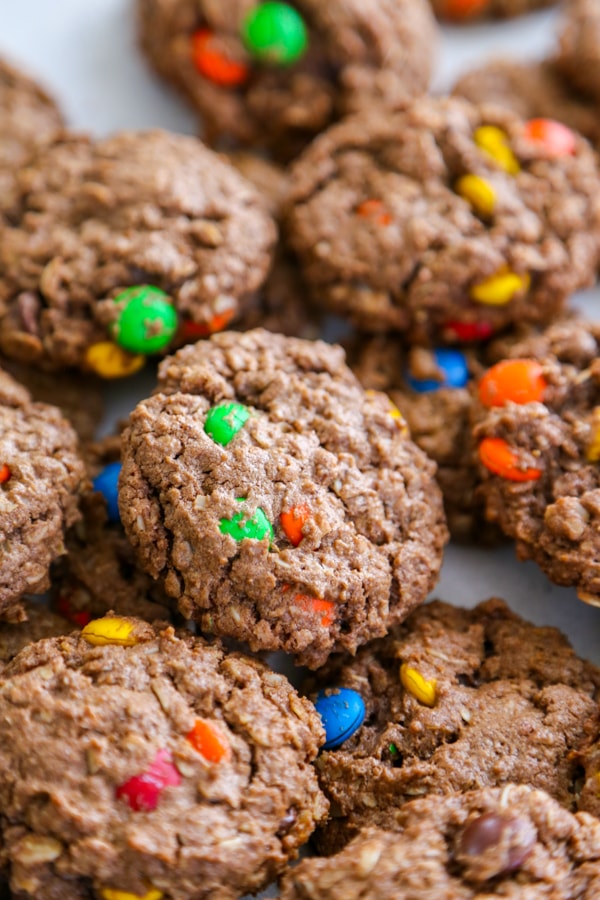 chocolate monster cookies in a pile.