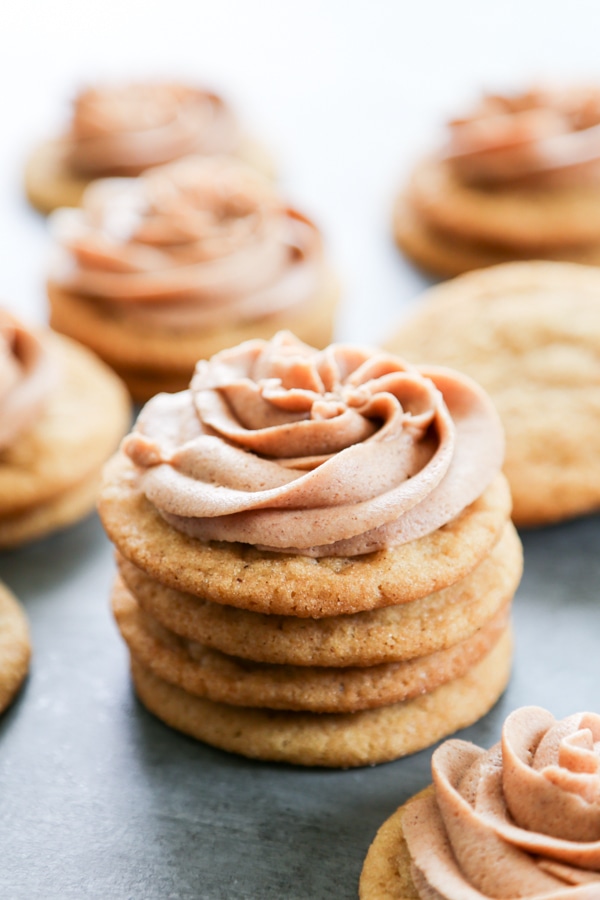 a stack of churro cookies topped with cinnamon frosting.