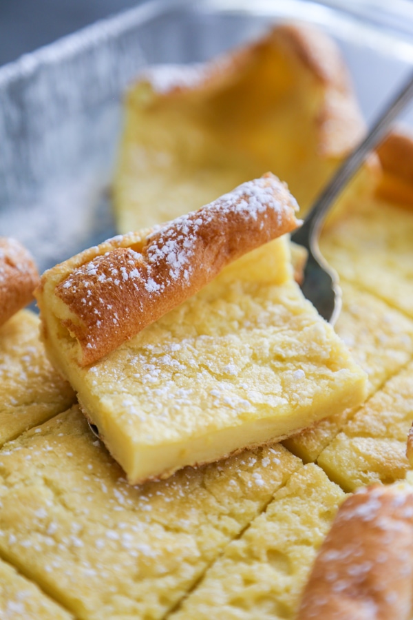 a slice of German pancake dusted with powdered sugar.