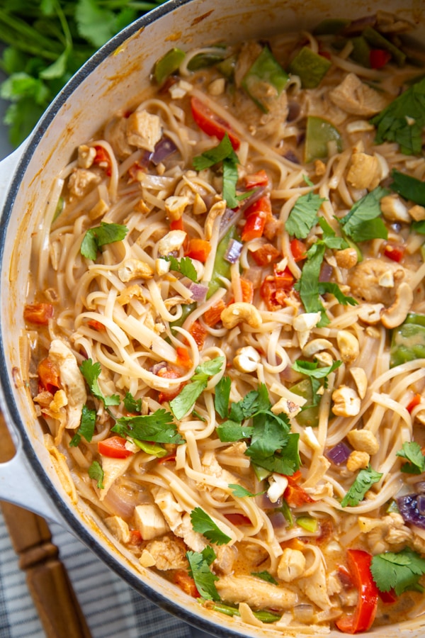 30 Minute Thai Chicken Soup is easy to make but has all the traditional flavors of a classic Thai soup: coconut, curry, cilantro, and fresh lime. The soup in a pot.