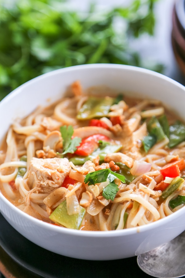 30 Minute Thai Chicken Soup is easy to make but has all the traditional flavors of a classic Thai soup: coconut, curry, cilantro, and fresh lime. A bolwl of Thai curry soup.