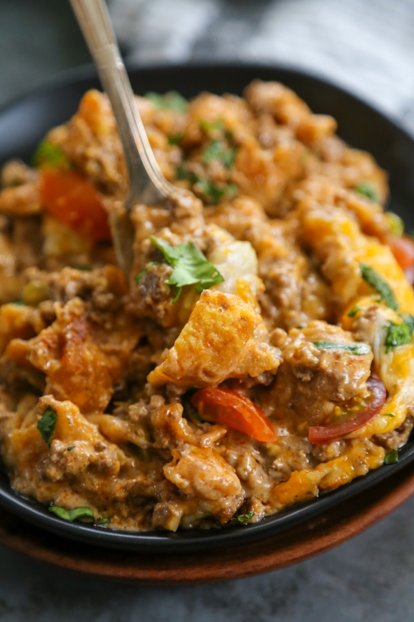 close up shot of beef enchilada bake on a plate.
