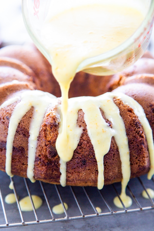 orange bundt cake with glaze orange bundt cake with a glaze being poured on it