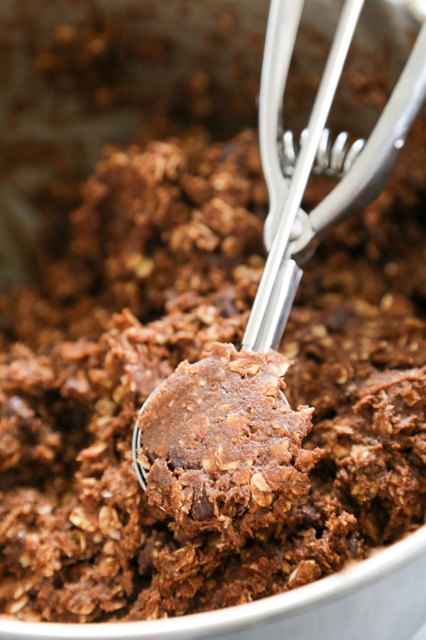 close-up shot of a bowl of cookie dough with a cookie scoop.