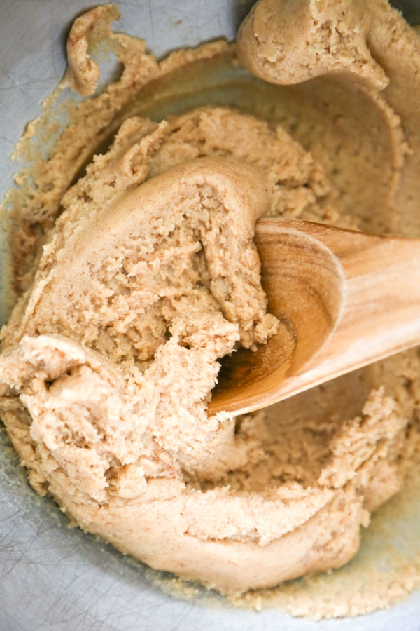 Snickerdoodle Cookie Dough Bites are the most amazing edible cookie dough you will ever eat! What makes these so special is the secret ingredient…caramel! the dough being mixed in a bowl.