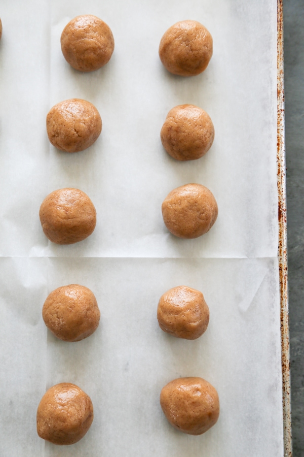 Snickerdoodle Cookie Dough Bites are the most amazing edible cookie dough you will ever eat! What makes these so special is the secret ingredient…caramel! overhead shot of the dough balls on a sheet pan.