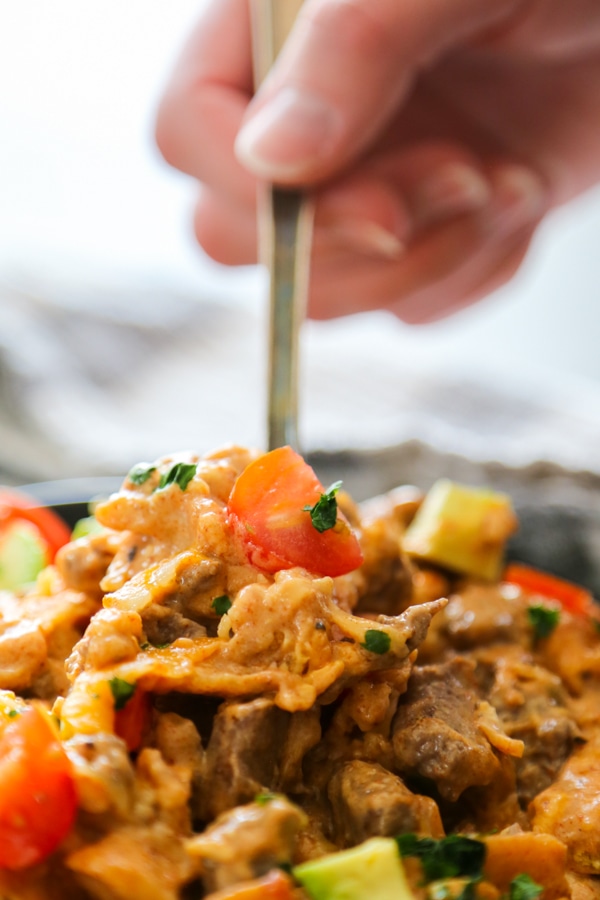 a close-up shot of the casserole getting scooped up with a spoon.