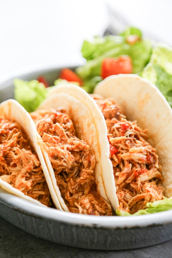 three tacos on a plate.