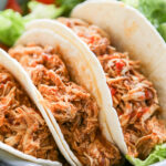 close-up shot of three chicken tacos.
