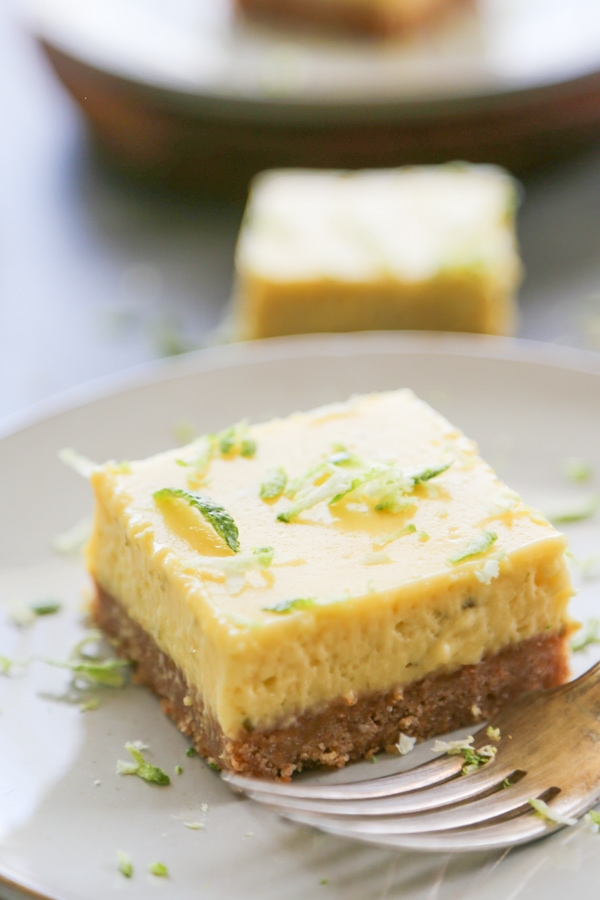 a key lime bar on a plate with a fork.