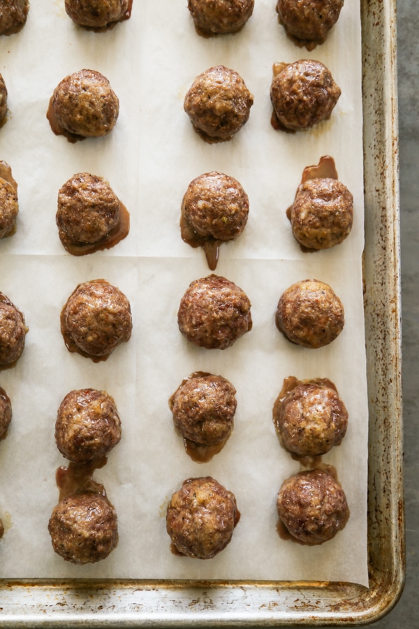 baked meatballs on a sheet pan.