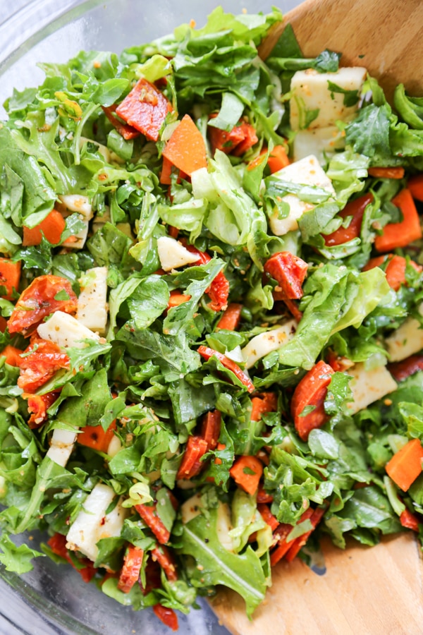 the salad being tossed together.