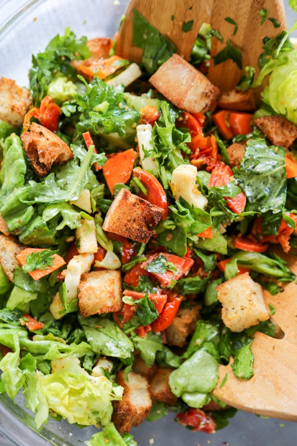 overhead shot of the salad being tossed together with croutons..