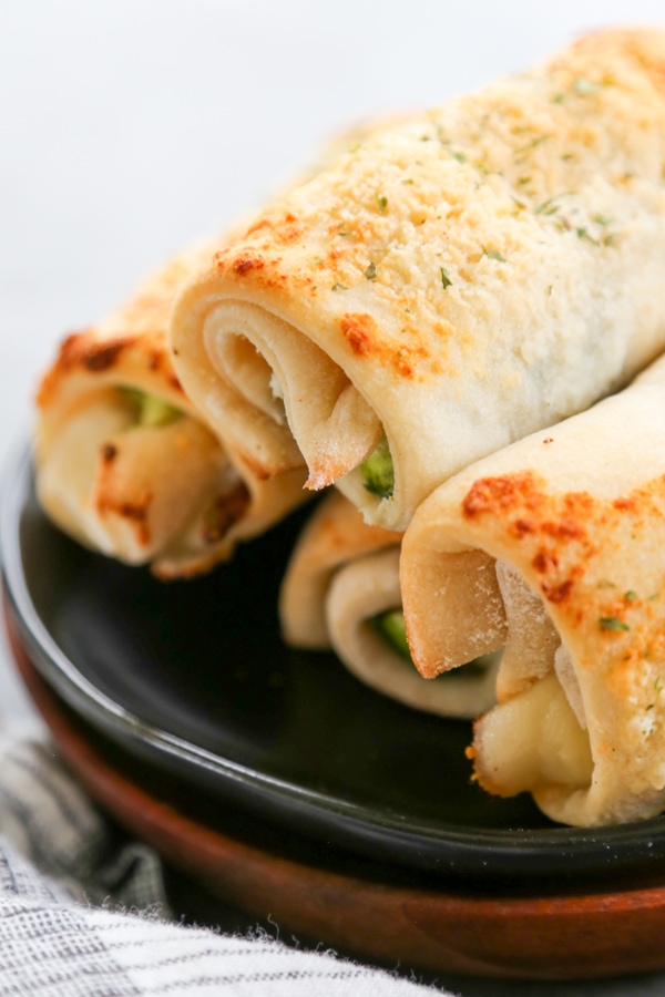 jalapeno breadsticks stacked on a plate.
