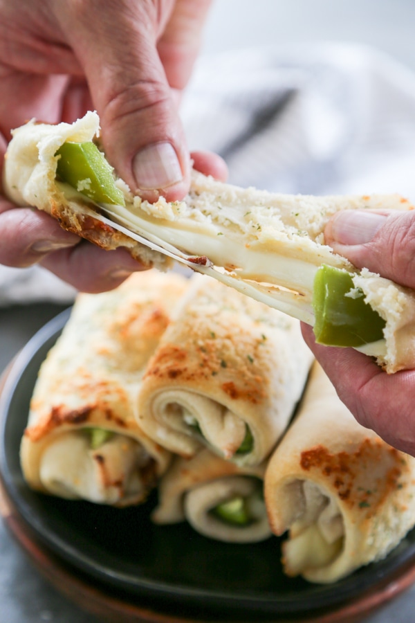 a jalapeno breadstick being pulled in half.